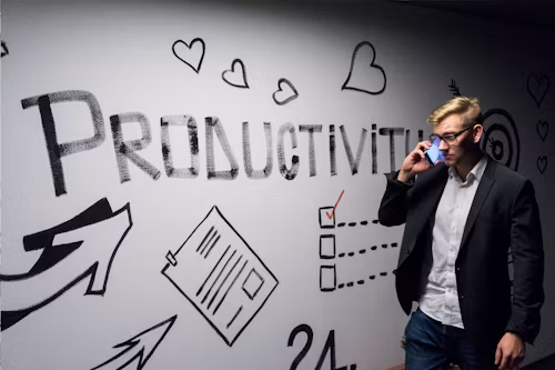 Man talking to his phone with the word productivity on the background
