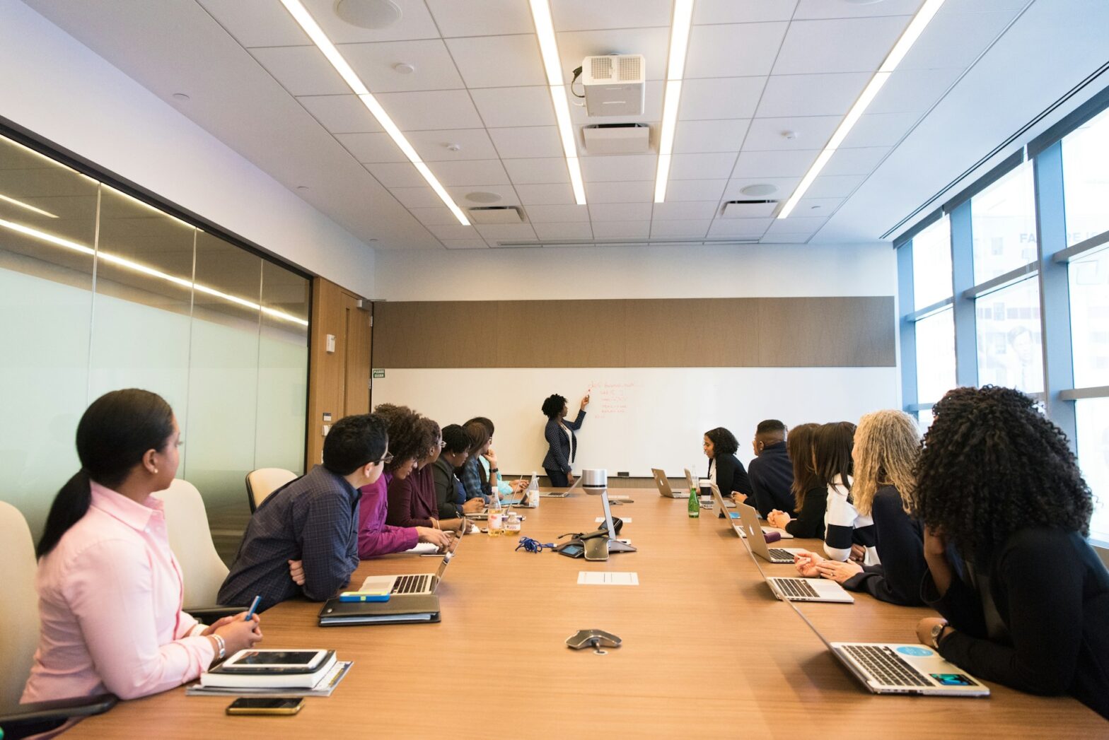 A group of people sitting in front of a conference table