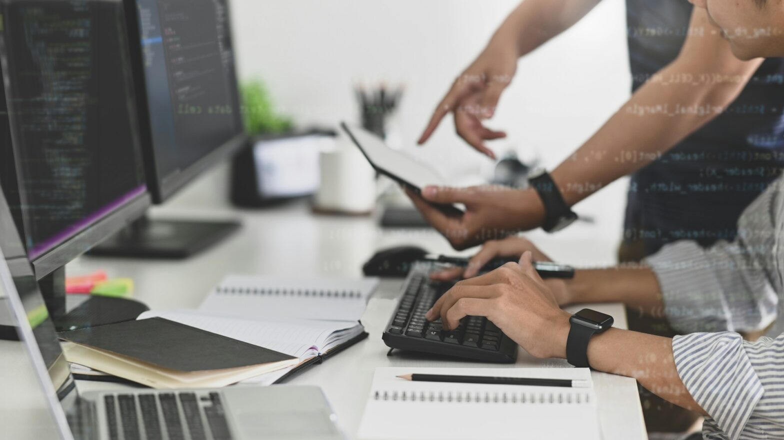 Two people in front of a computer